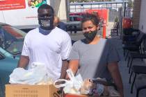 Lekarrie Evans and Lache Campbell pose with the food they received from City Impact's food bank ...