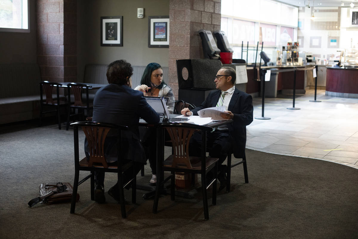 Alisha Burns speaks with her lawyer Tony Abbatangelo, right, and law clerk Robert Rose, left, b ...