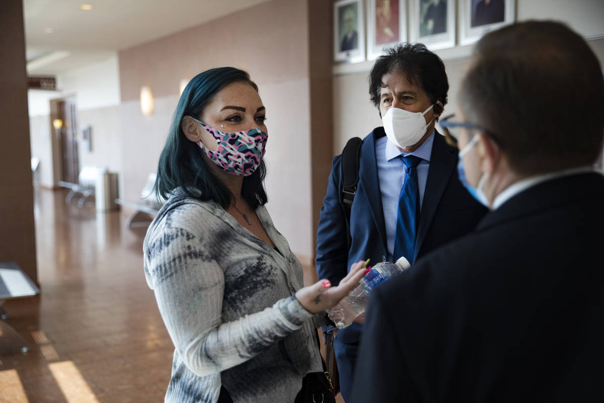 Alisha Burns speaks with her lawyer Tony Abbatangelo, right, and law clerk Robert Rose, center, ...