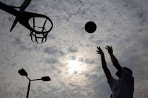 Matthew Chavez is silhouetted as he plays basketball at Charlie Frias Park, on Friday, Sept. 18 ...