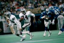 Running back Bo Jackson (34) of the Los Angeles Raiders follows Dokie Williams (85) for a four ...