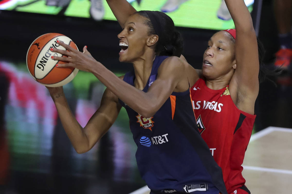 Connecticut Sun's DeWanna Bonner, left, drives past Las Vegas Aces' A'ja Wilson during the firs ...