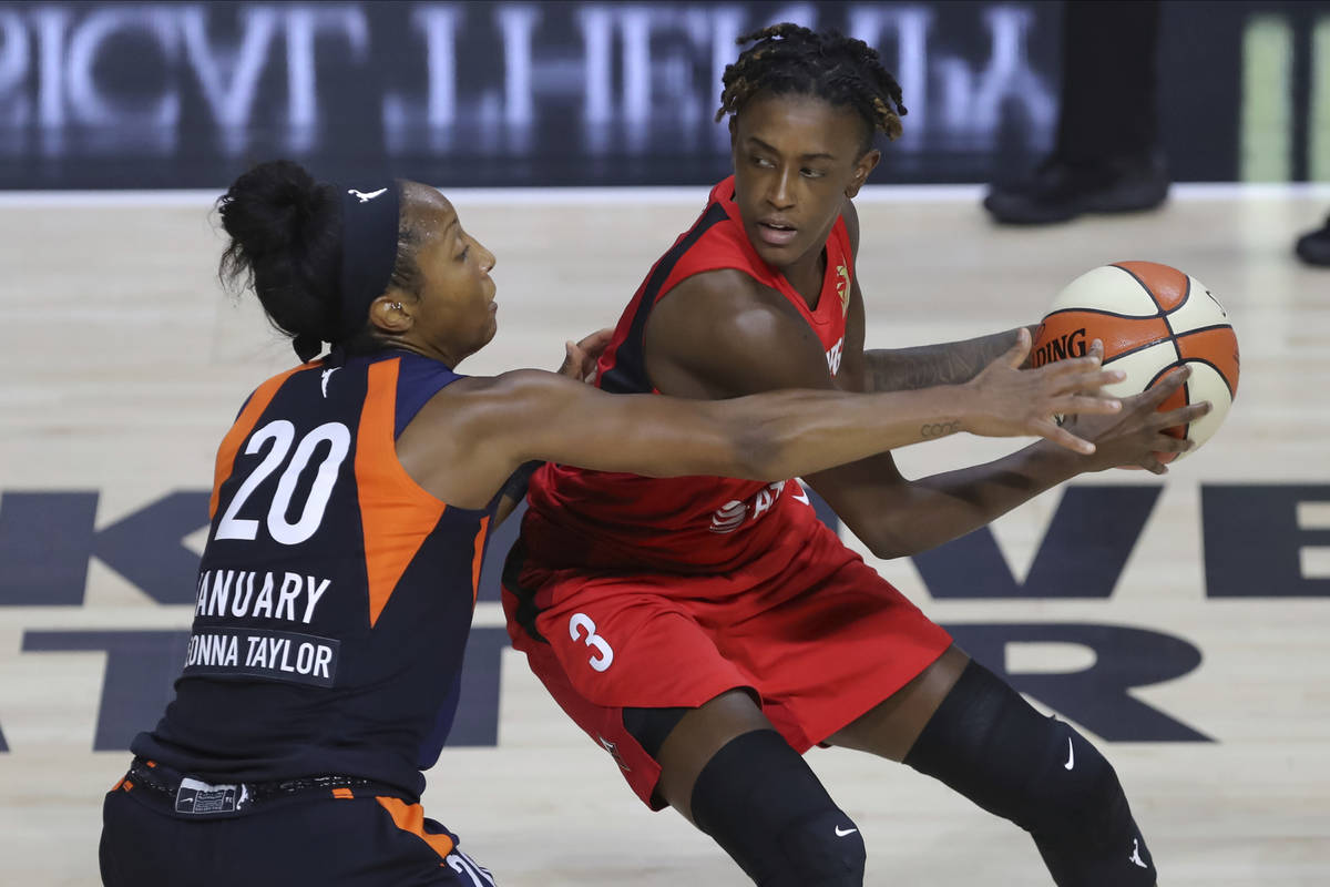 Las Vegas Aces' Danielle Robinson (3) avoids the defense of Connecticut Sun's Briann January du ...