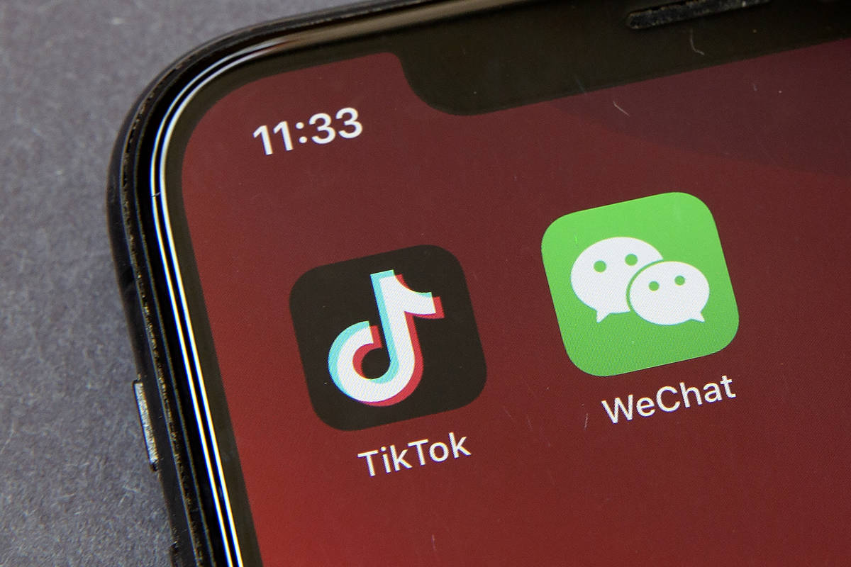 Icons for the smartphone apps TikTok and WeChat are seen on a smartphone screen in Beijing, in ...