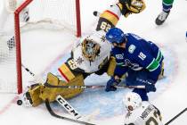 Vegas Golden Knights goalie Marc-Andre Fleury (29) makes a save on Vancouver Canucks' Jake Virt ...