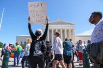 Kelli Midgley, center, an English teacher from Baltimore, joins people gathered at the Supreme ...