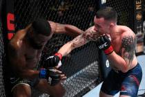 Colby Covington, right, punches Tyron Woodley in their welterweight bout during the UFC Fight N ...