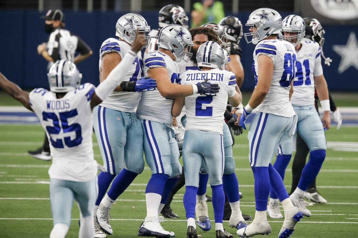 Dallas Cowboys kicker Greg Zuerlein (2) is congratulated by his teammates after kicking the gam ...