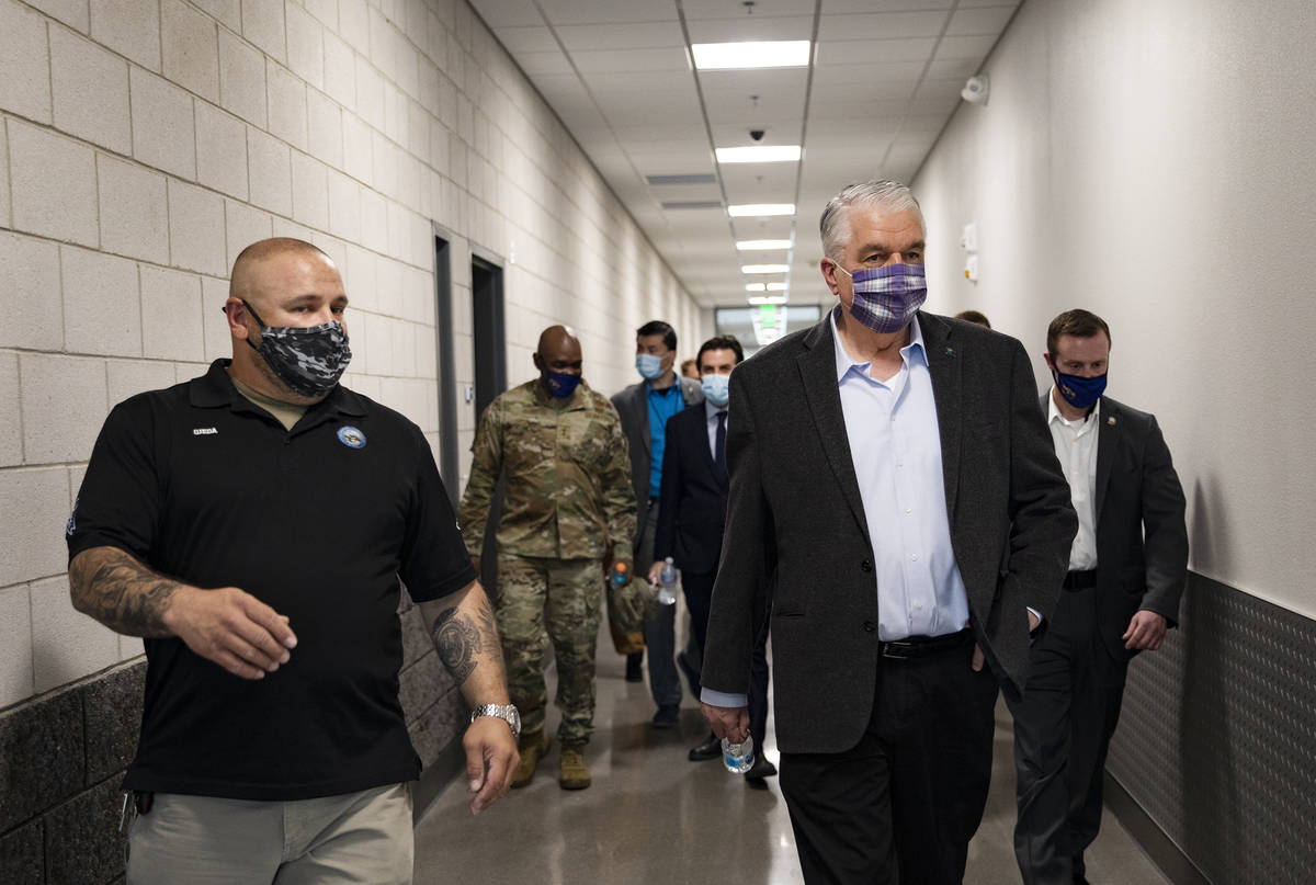 Core construction project superintendent Edward Ojeda, left, leads a tour for Gov. Steve Sisola ...