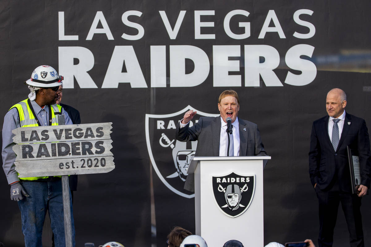Las Vegas Raiders owner Mark Davis, center, addresses the crowd beside team president Marc Bada ...