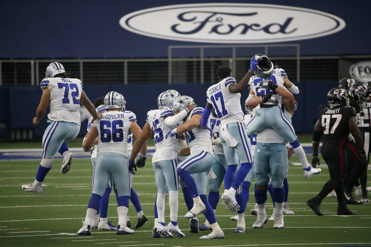 The Dallas Cowboys celebrate a field goal in the closing seconds of an NFL football game as Atl ...