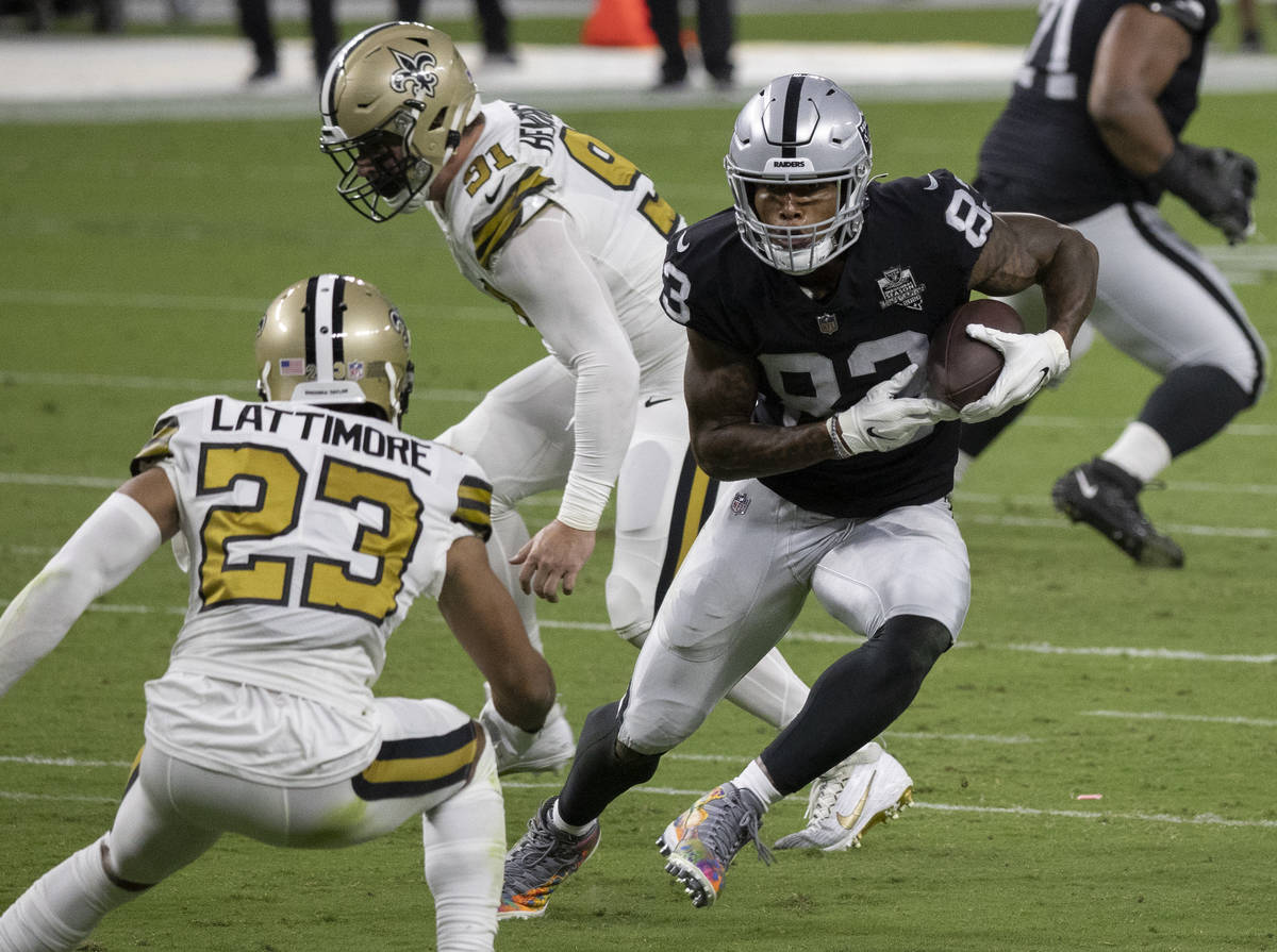 Las Vegas Raiders tight end Darren Waller (83) makes a catch and run past New Orleans Saints co ...