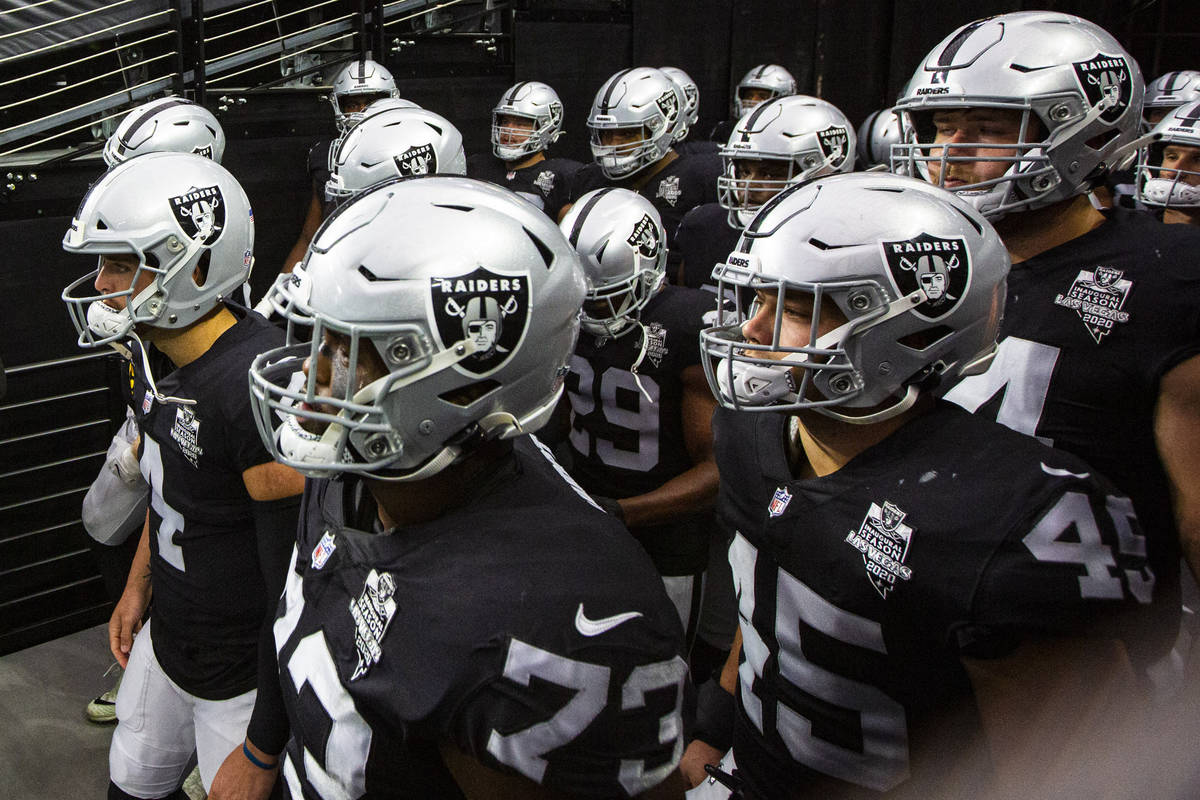 Las Vegas Raiders players get ready to take the field for the start of their home opening NFL g ...