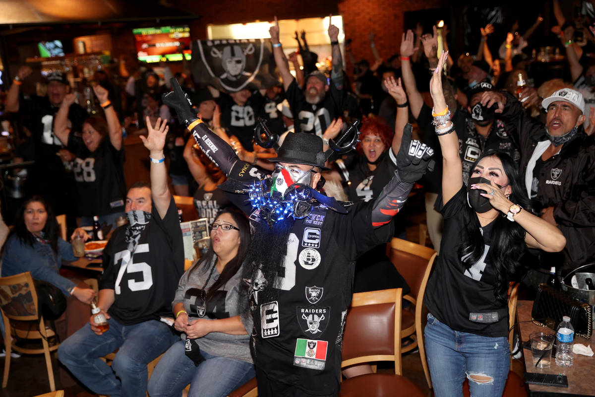 Las Vegas Raiders fans, including Cesar Resendiz and his wife Maria Andrade of Tucson, Ariz. ch ...