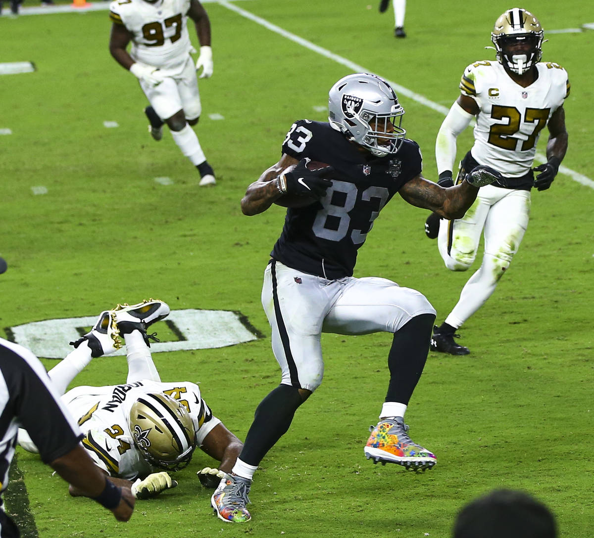 Las Vegas Raiders tight end Darren Waller (83) runs the ball past New Orleans Saints defensive ...