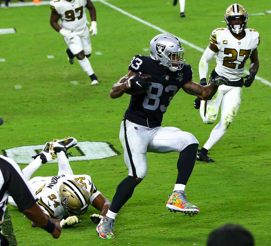 Las Vegas Raiders tight end Darren Waller (83) runs the ball past New Orleans Saints defensive ...