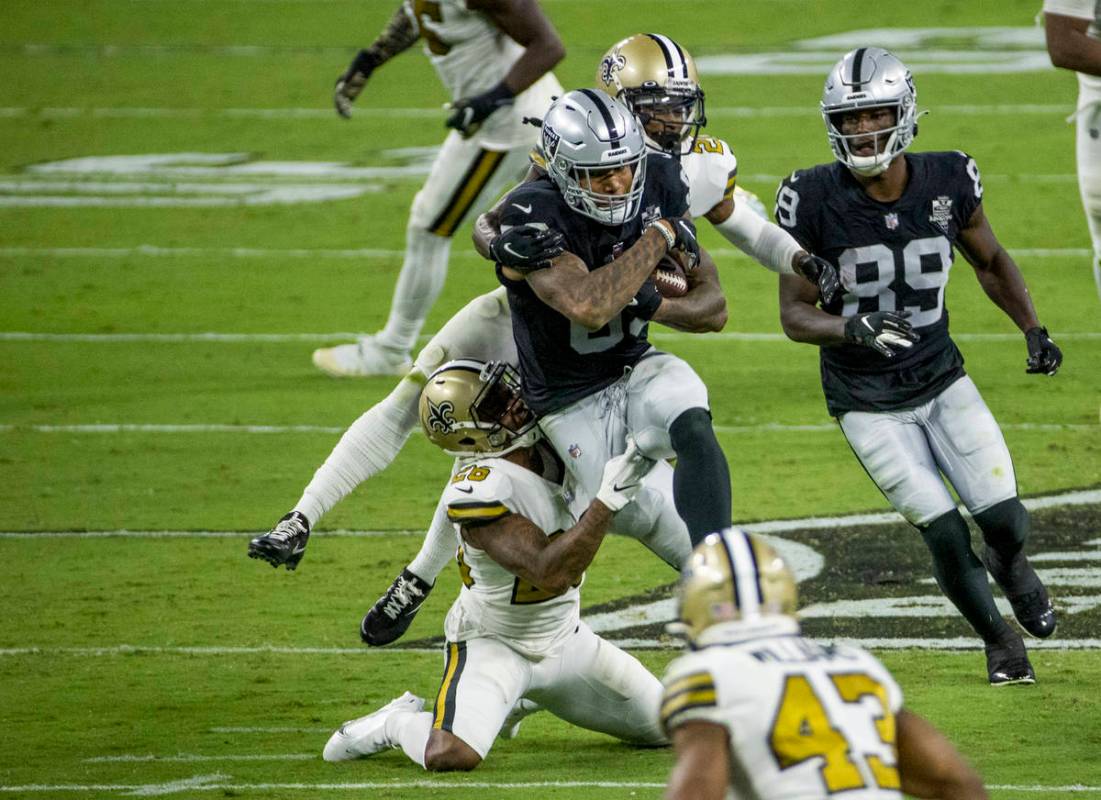 Las Vegas Raiders tight end Darren Waller (83) battles through a tackle attempt by New Orleans ...