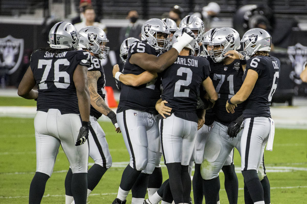 Las Vegas Raiders kicker Daniel Carlson (2) is congratulated by teammates on his late-game fiel ...