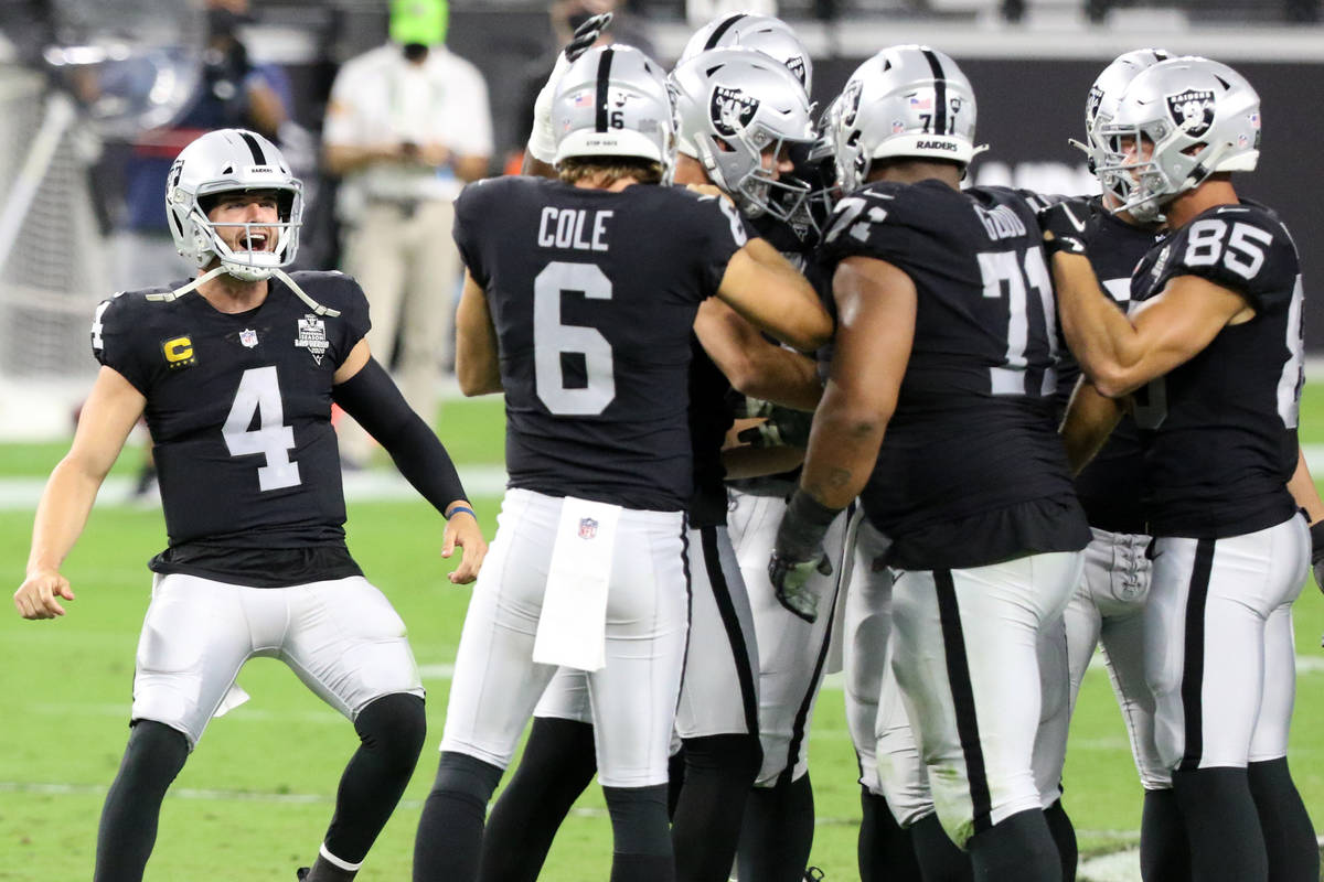 Las Vegas Raiders quarterback Derek Carr (4) runs on the field to congratulate kicker Daniel Ca ...