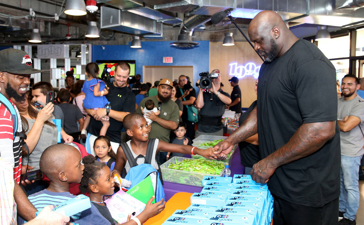 Mishawn Ricks, 9, of Las Vegas, shakes hands with former NBA star Shaquille O'Neal during Shaq- ...