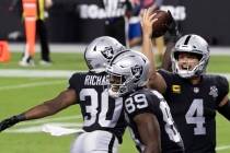 Las Vegas Raiders quarterback Derek Carr (4) celebrates with Las Vegas Raiders running back Jal ...