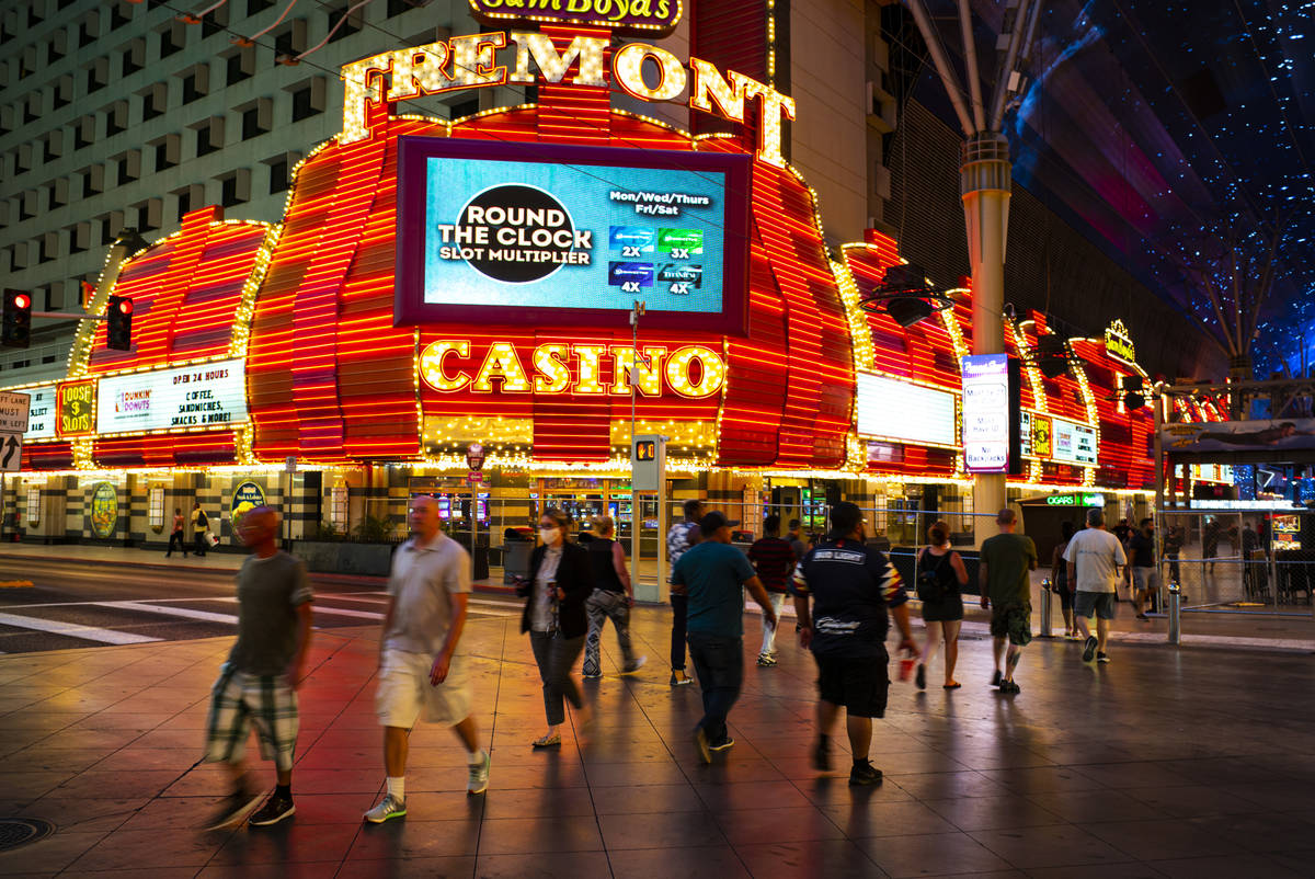 People cross Casino Center Boulevard outside of the Fremont as hotel-casinos reopen in downtown ...