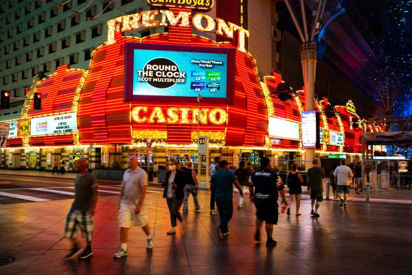 People cross Casino Center Boulevard outside of the Fremont as hotel-casinos reopen in downtown ...