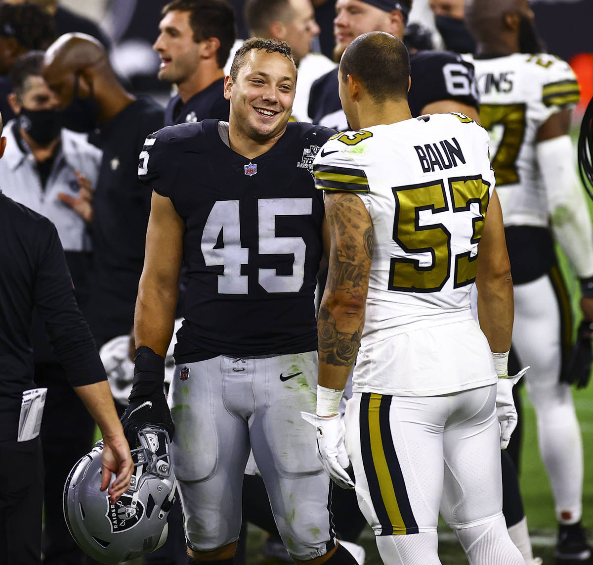 Las Vegas Raiders fullback Alec Ingold (45) talks with New Orleans Saints linebacker Zack Baun ...