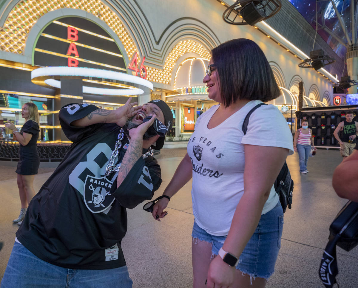 Raiders fans from Rio Rancho, New Mexico, Christopher Rodarte, left, and Juliet Cardozo, celebr ...