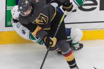 Vancouver Canucks' J.T. Miller (9) is checked by Vegas Golden Knights' Alex Tuch (89) during se ...