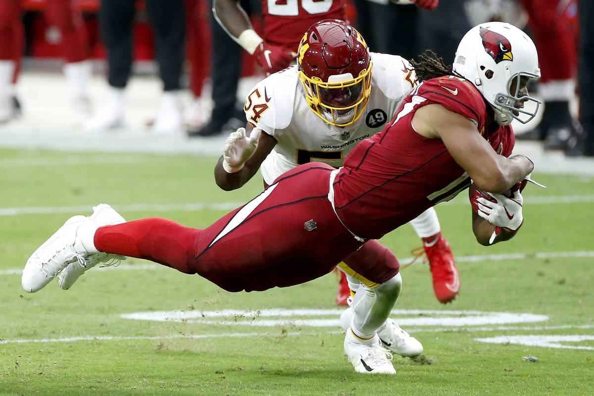 Arizona Cardinals wide receiver Larry Fitzgerald makes a catch as Washington Football Team line ...