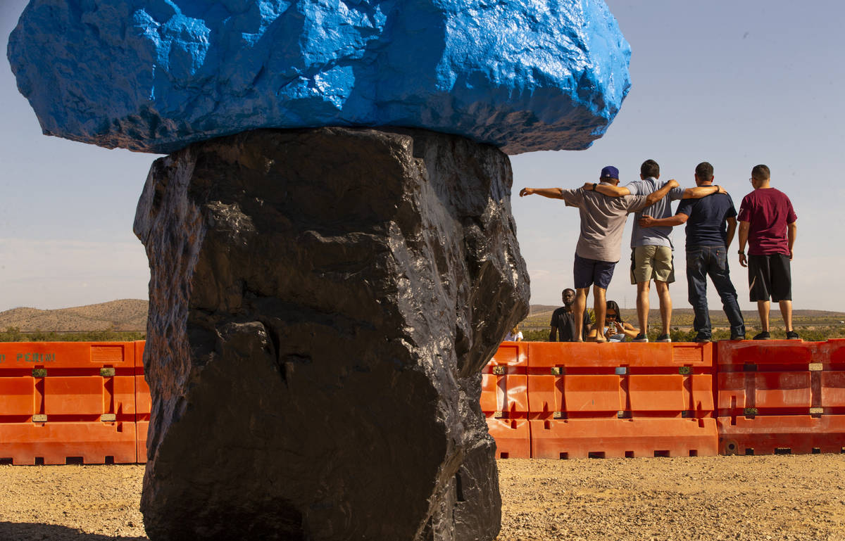 Visitors pose for a photo atop barricades on June 14. More than 321,000 people visited the site ...