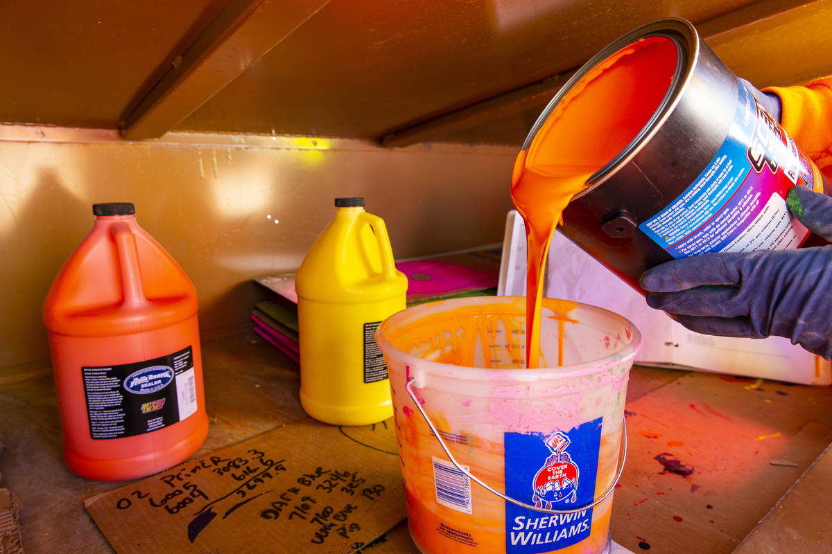 John Henderson mixes a batch of orange finish on June 17. The bright colors are typical of a Ro ...