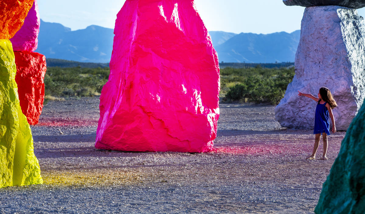 Light reflects off the newly restored Seven Magic Mountains on June 18. Ugo Rondinone merged la ...