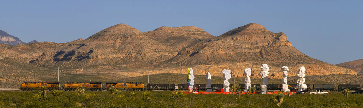 A train rolls by the Seven Magic Mountains on June 4. The installation is the largest land art ...