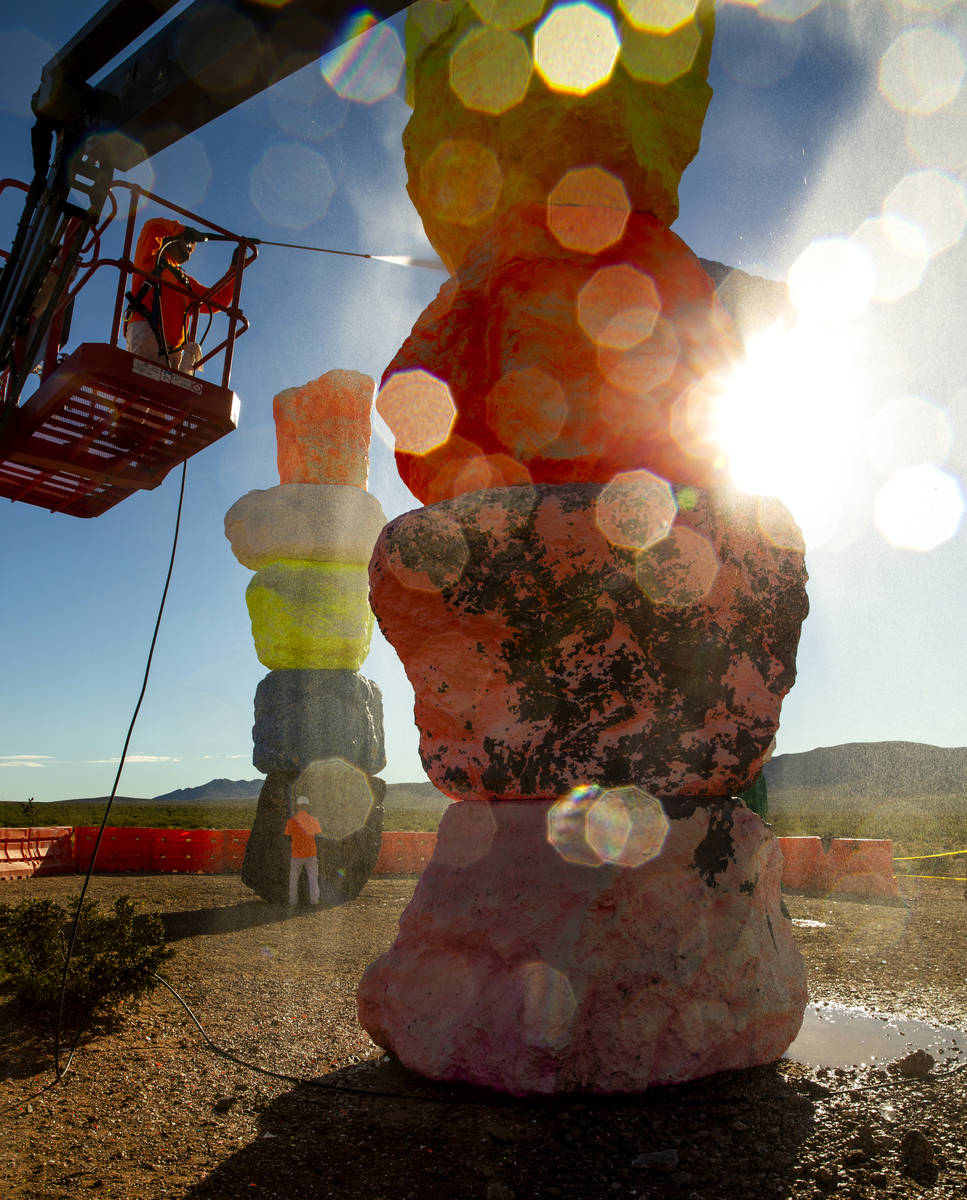 Ivan Ibarra pressure washes a tower after a week of high winds and other safety concerns delaye ...