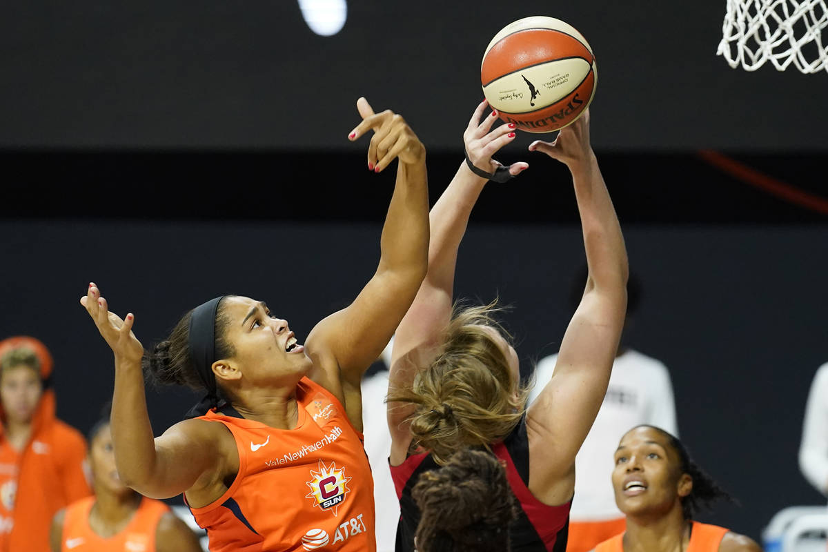 Connecticut Sun center Brionna Jones (42) blocks a shot by Las Vegas Aces center Carolyn Swords ...