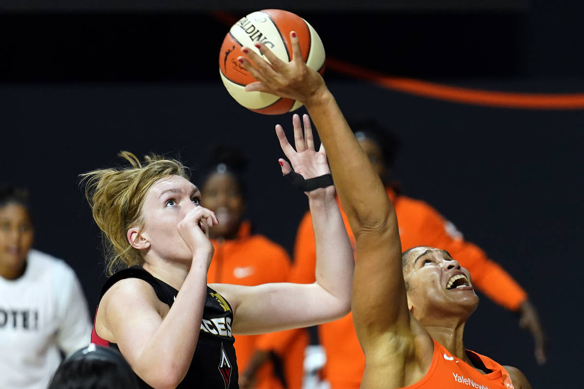 Connecticut Sun center Brionna Jones (42) loses control of the ball after getting hit by Las Ve ...