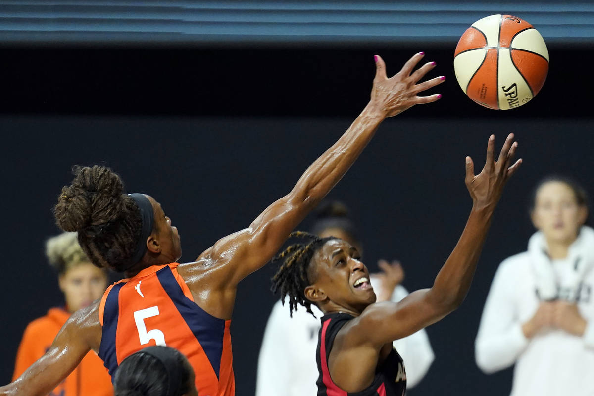 Las Vegas Aces guard Danielle Robinson (3) shoots over Connecticut Sun guard Jasmine Thomas (5) ...