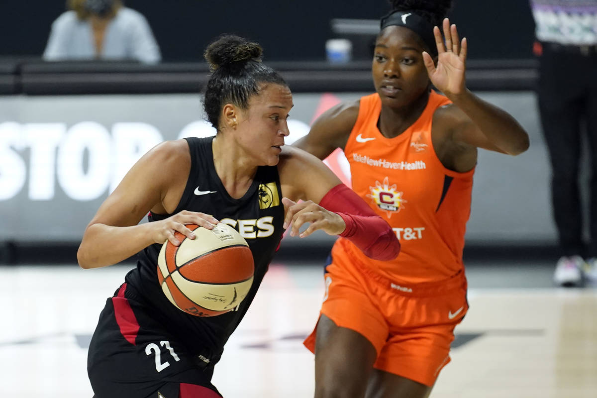 Las Vegas Aces guard Kayla McBride (21) drives against Connecticut Sun guard Kaila Charles (3) ...