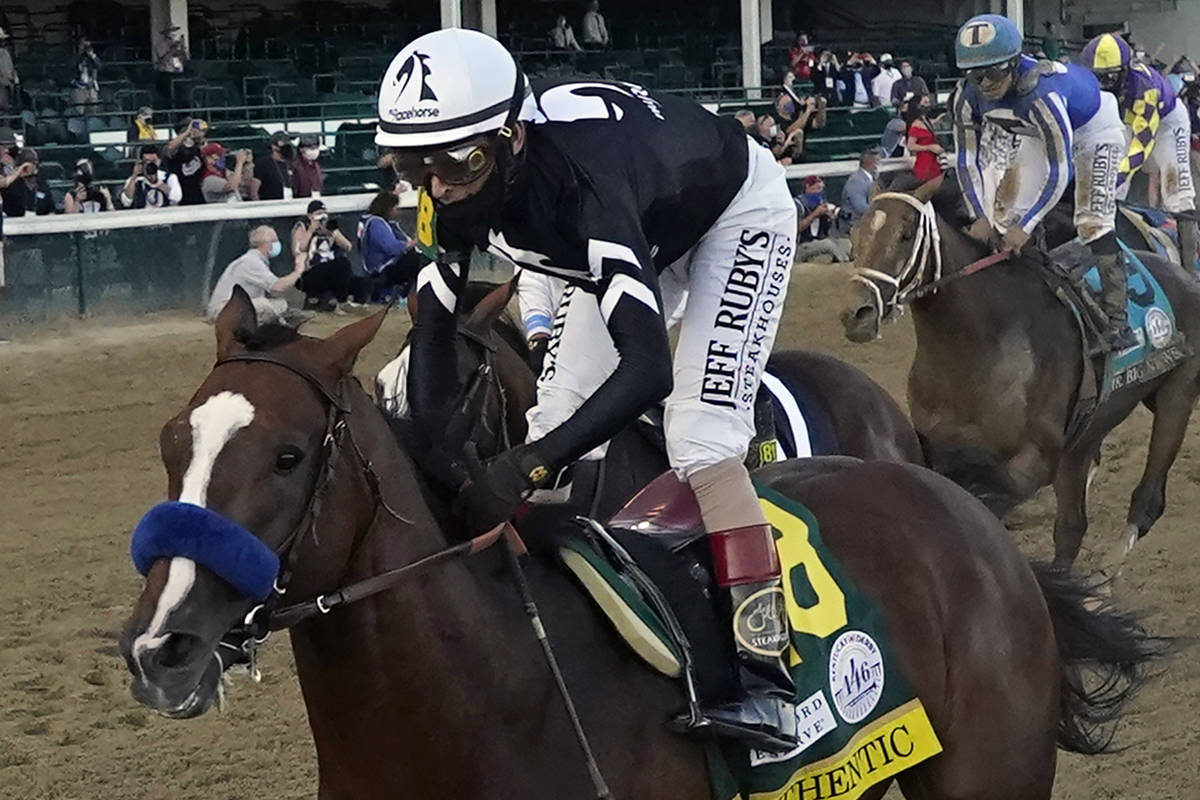 Jockey John Velazquez rides Authentic to win the 146th running of the Kentucky Derby at Churchi ...