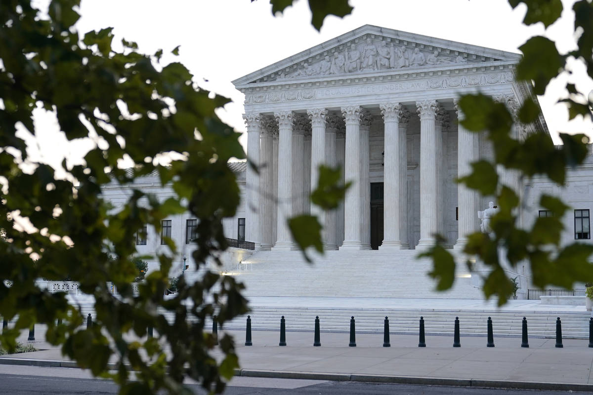 The sun rises behind the Supreme Court in Washington, Wednesday, Sept. 23, 2020, before a priva ...