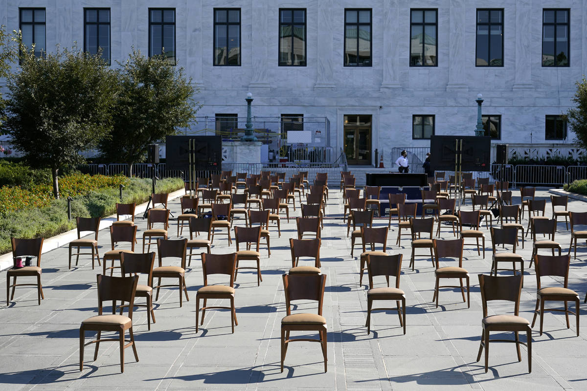 Socially-distant chairs sit on a plaza outside the Supreme Court on Capitol Hill in Washington, ...