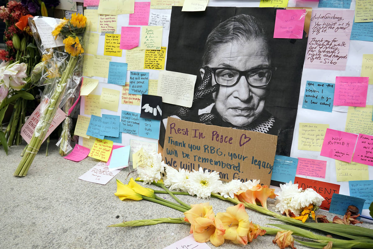 A memorial to U.S. Supreme Court Justice Ruth Bader Ginsburg includes a photograph of the late ...