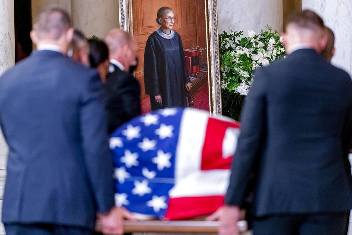 The flag-draped casket of Justice Ruth Bader Ginsburg, carried by Supreme Court police officers ...