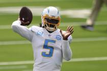Los Angeles Chargers quarterback Tyrod Taylor (5) warms up before an NFL football game between ...