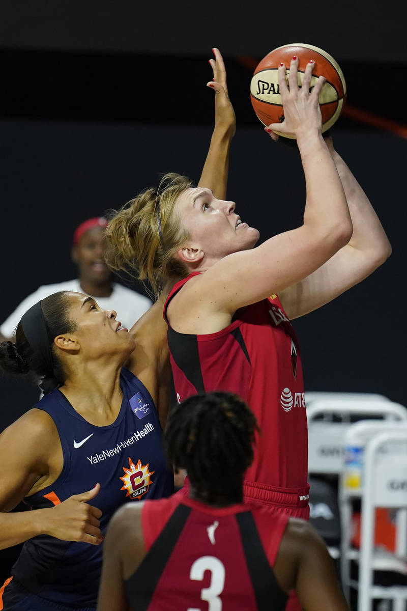 Las Vegas Aces center Carolyn Swords (4) shoots over Connecticut Sun center Brionna Jones (42) ...