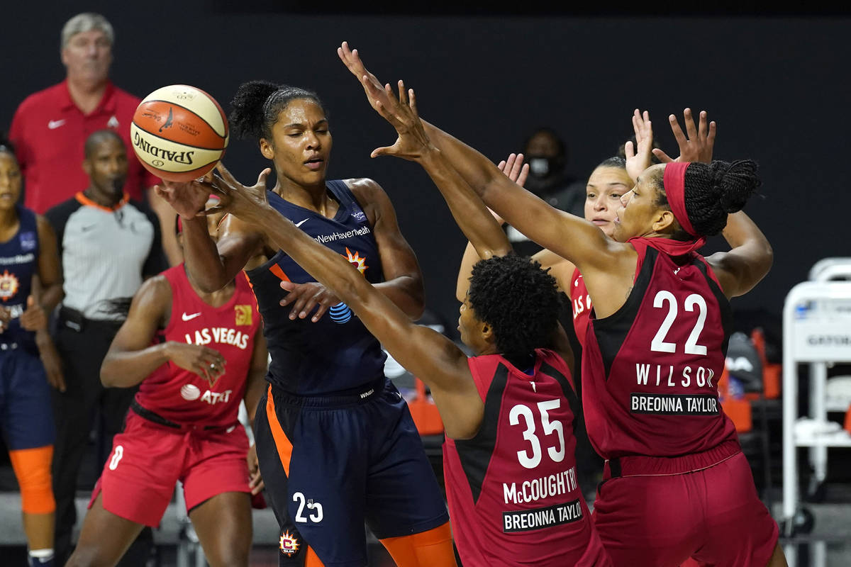 Connecticut Sun forward Alyssa Thomas (25) pass the ball as she is guarded by Las Vegas Aces fo ...