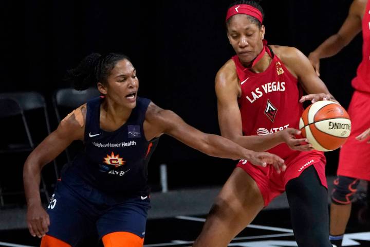 Connecticut Sun forward Alyssa Thomas (25) knocks the ball away from Las Vegas Aces center A'ja ...