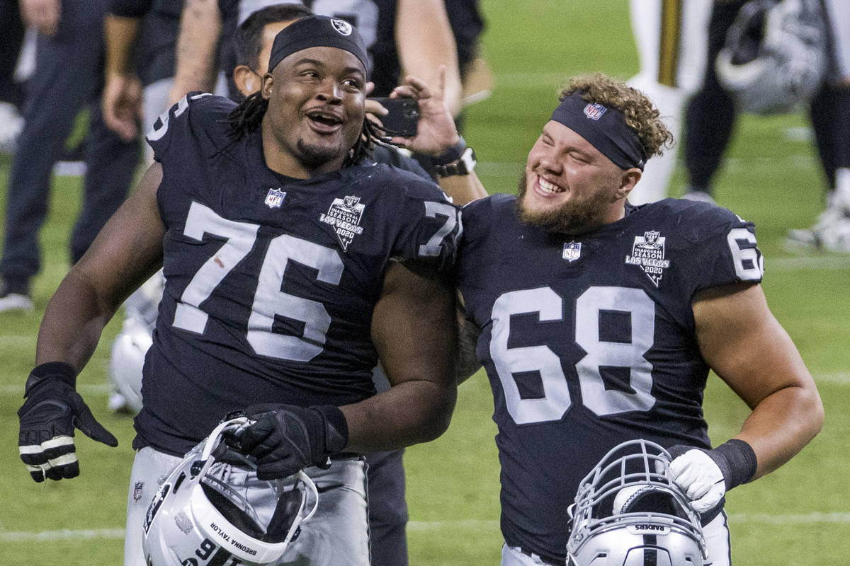 Las Vegas Raiders offensive guard John Simpson (76, left) and offensive  tackle Andre James (68) …
